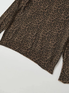 Detail view of leopard print knit sweater showing ribbed hem and cuff texture