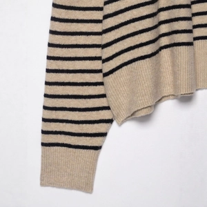 Classic striped knit sweater in beige and black with ribbed cuffs and hem details