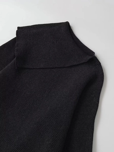 Detail view of black ribbed knit turtleneck sweater with fine vertical stripe texture