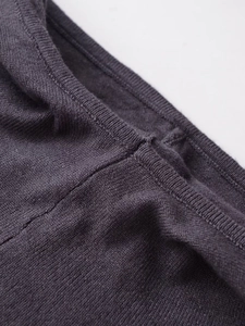 Detailed macro view showing the fine knit texture and flat seams of the slim dress