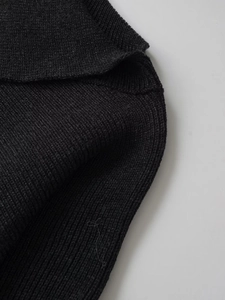 Close-up of the premium dark ribbed knit fabric showing detailed texture and stitching