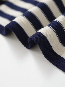 Gros plan sur le tissu en maille rayé bleu et blanc avec une texture côtelée