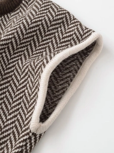 Close-up detail of herringbone knit pattern with premium ribbed edge on vest top