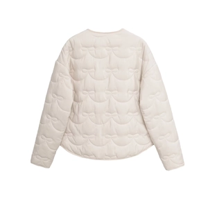 Close-up of the back view showing bow-shaped quilted stitching on the beige jacket