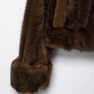 Deep brown faux fur jacket with smooth texture and high-gloss finish shown in detail
