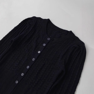 Classic black alpaca blend knit cardigan with round neck and textured button-down detail