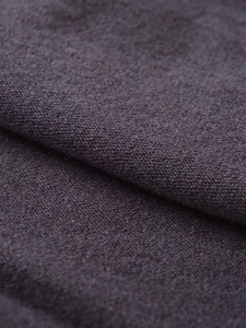 Close-up of premium dark grey knitted fabric showing fine texture and soft wool blend material