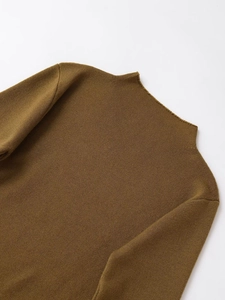 Detail of a brown ribbed knit sweater showing the seamless high neck and soft texture