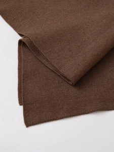 Close-up of high-density dark brown knit fabric texture and premium hem finish