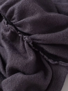 Detailed macro view of high-quality knit fabric texture and elastic seam reinforcement