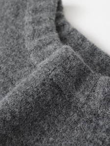 Close-up of premium dark grey rib-knit fabric with soft wool-like fuzzy texture