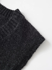 Macro detail of dark grey rib-knit texture and soft wool-blend fabric of the vest