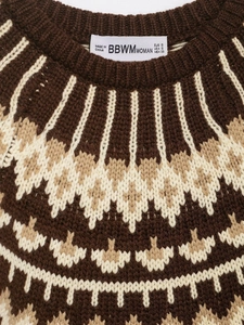 Close-up of knit sweater neckline with geometric jacquard pattern and BBWMWOMAN brand label