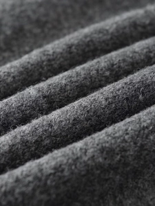 Close-up detail of dark grey ribbed knit fabric with soft wool texture for winter wear