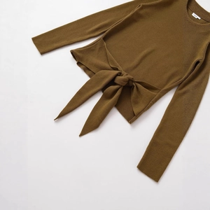 Slim fit brown ribbed knit long sleeve top featuring a stylish front bow knot detail