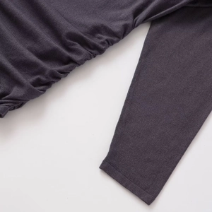 Slim fit charcoal grey knitted hooded dress featuring elegant side ruching and ribbed cuffs