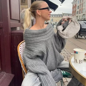 Detailed view of grey oversized off-shoulder sweater with thick vertical rib knit texture
