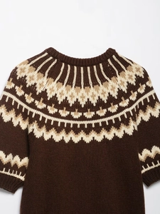 Close-up of vintage brown Fair Isle jacquard knit sweater with classic round neckline