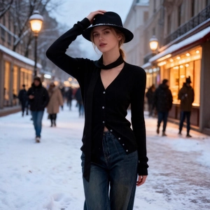 Slim fit black ribbed knit cardigan with buttons and scarf detail in snowy street setting
