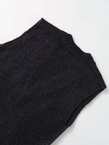 Close-up of the ribbed neckline and wool texture on a dark grey knit sweater vest