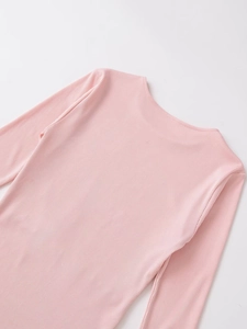 Détail de la maille côtelée rose au dos de ce haut ajusté à manches longues pour femmes