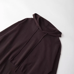 Deep brown knitted hoodie with drawstring and ribbed hem shown in a flat lay view