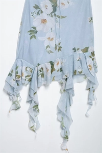 Detailed view of light blue floral chiffon dress with asymmetric layered ruffles