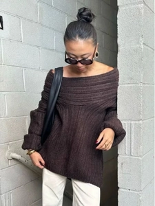 Detail of a dark brown off-the-shoulder knit sweater with distinct vertical ribbed texture