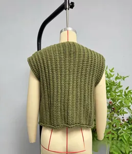 Macro shot of dark green chunky knit vest showing vertical rib texture and round neck