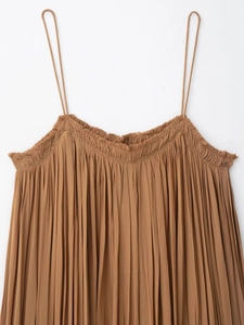Close-up of pleated neckline with gold bead trim on a tan camisole dress