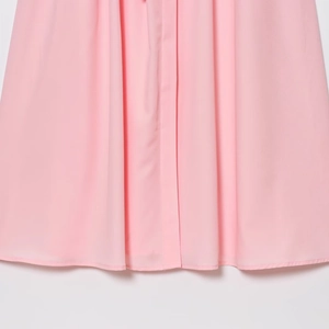 Detail shot of the pink dress hemline featuring premium stitching and lightweight fabric