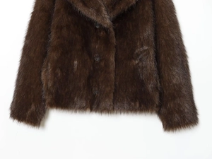Detail of dark brown faux fur jacket showing wide lapel and three black buttons