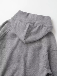Detailed view of the dark grey knitted hoodie hood and shoulder stitching quality
