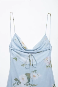 Detail of light blue floral dress showing draped neckline and thin spaghetti straps