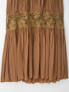 Close-up of caramel pleated dress featuring intricate floral lace hollow-out embroidery