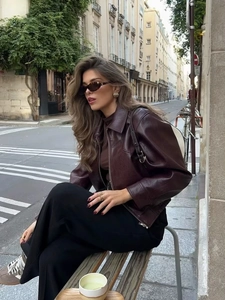 Dettaglio giacca in ecopelle marrone scuro con zip argento e colletto vintage
