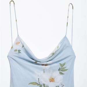 Light blue floral cowl neck mini dress with thin straps and white flower print