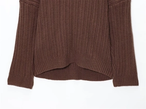 Detailed view of the dark brown sweater showing the vertical ribbed knit texture