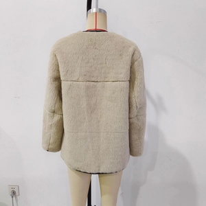 Back view of beige faux fur coat featuring dense plush texture and circular neckline