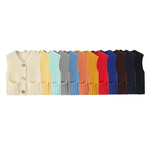 Detailed macro view of V-neck sleeveless knit vests in multiple vibrant colors and textures