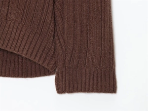 Detail shot of wide-ribbed knit fabric cuffs in a deep coffee brown solid color