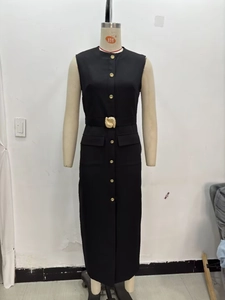 Detail of black sleeveless midi dress with gold buttons and a wavy buckle belt