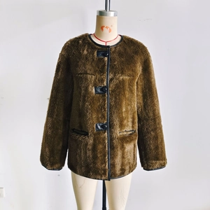 Detailed view of brown faux fur jacket featuring leather trim and black buttons