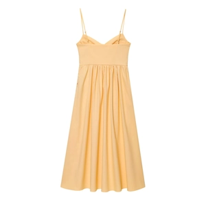 Detail of light yellow summer midi dress with pleated bodice and slim spaghetti straps
