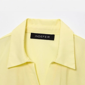 Classic light yellow poplin midi dress with shirt collar and textured woven fabric