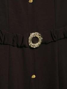 Detailed view of dark woven fabric and premium embossed gold buckle with vintage texture