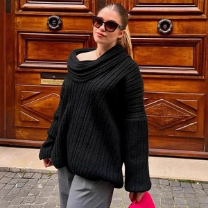 Oversized black cable-knit sweater for women featuring a slouchy off-shoulder neckline style