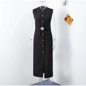 Detail of black sleeveless midi dress with gold buttons and ornate waist belt buckle