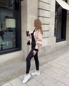 Street style view of a beige oversized shacket with large pockets and drop shoulder design