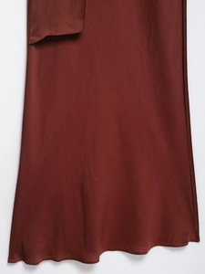 Détail du tissu de la robe midi marron rouge avec le rabat de la poche latérale bien visible